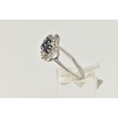 52 - AN 18CT WHITE GOLD SAPPHIRE AND DIAMOND RING, designed as a central oval sapphire flanked by circula... 