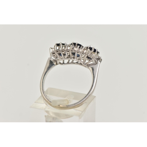 52 - AN 18CT WHITE GOLD SAPPHIRE AND DIAMOND RING, designed as a central oval sapphire flanked by circula... 