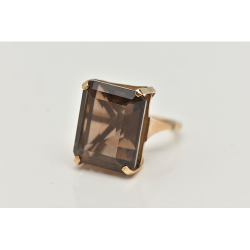 8 - A YELLOW METAL SMOKY QUARTZ DRESS RING, rectangular cut smoky quartz, measuring approximately length... 