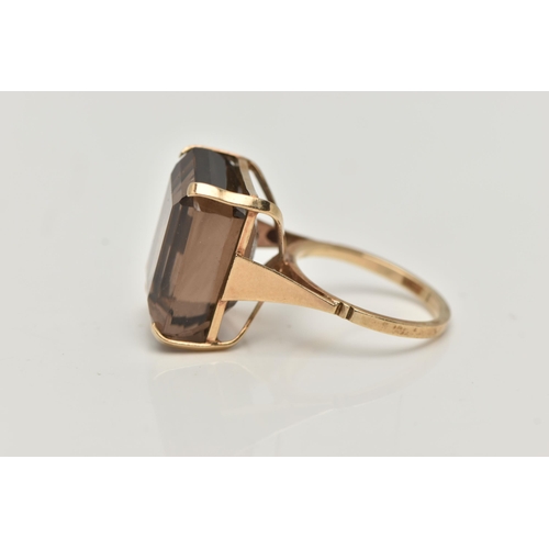 8 - A YELLOW METAL SMOKY QUARTZ DRESS RING, rectangular cut smoky quartz, measuring approximately length... 