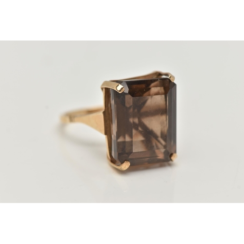 8 - A YELLOW METAL SMOKY QUARTZ DRESS RING, rectangular cut smoky quartz, measuring approximately length... 