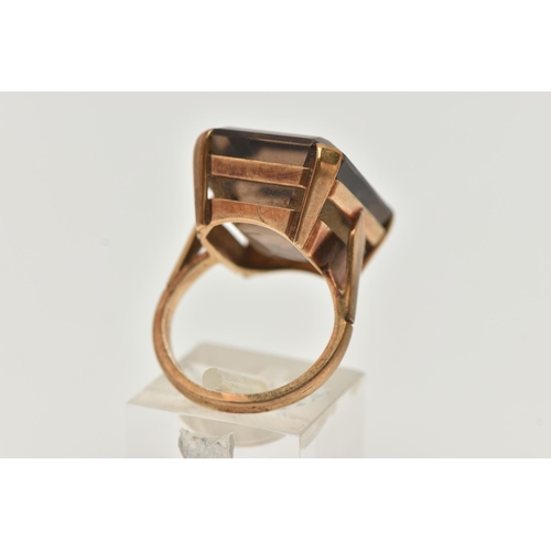 9 - A YELLOW METAL SMOKY QUARTZ DRESS RING, rectangular cut smoky quartz, measuring approximately length... 