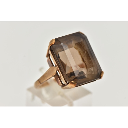 9 - A YELLOW METAL SMOKY QUARTZ DRESS RING, rectangular cut smoky quartz, measuring approximately length... 