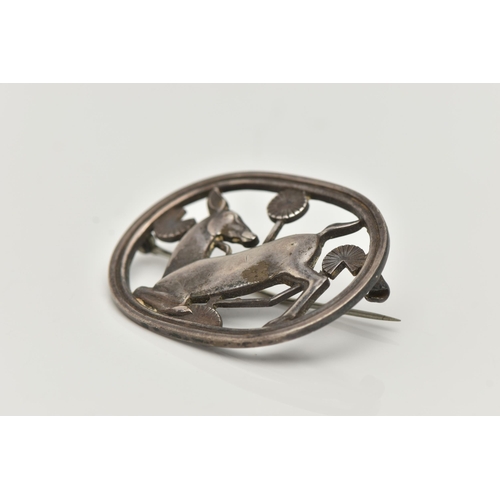 67 - A 'GEORG JENSEN' SILVER BROOCH, open work kneeling deer design in oval surround, measuring approxima... 