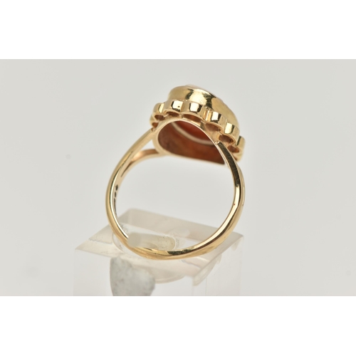 70 - A 9CT GOLD CAMEO RING, carved shell cameo, collet set within a fine rope twist and scallop surround,... 