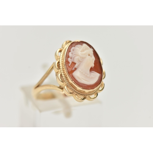 70 - A 9CT GOLD CAMEO RING, carved shell cameo, collet set within a fine rope twist and scallop surround,... 