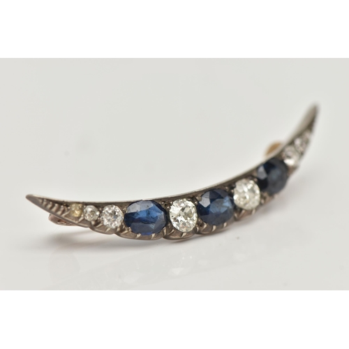 75 - A LATE VICTORIAN DIAMOND AND SAPPHIRE CRESCENT BROOCH, set with three oval cut blue sapphires, inter... 