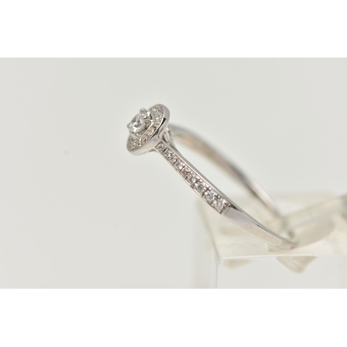 89 - A DIAMOND HALO RING, a single round brilliant cut diamond in a four prong white gold setting, grain ... 