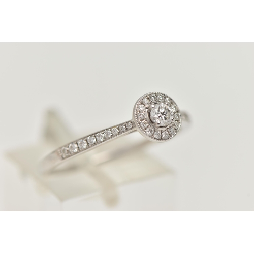 89 - A DIAMOND HALO RING, a single round brilliant cut diamond in a four prong white gold setting, grain ... 