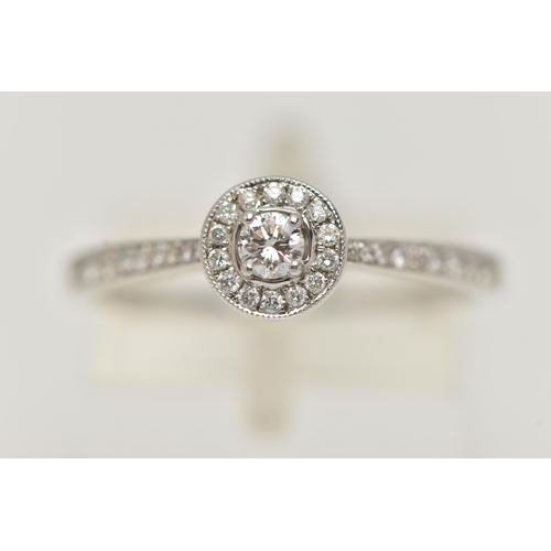 89 - A DIAMOND HALO RING, a single round brilliant cut diamond in a four prong white gold setting, grain ... 