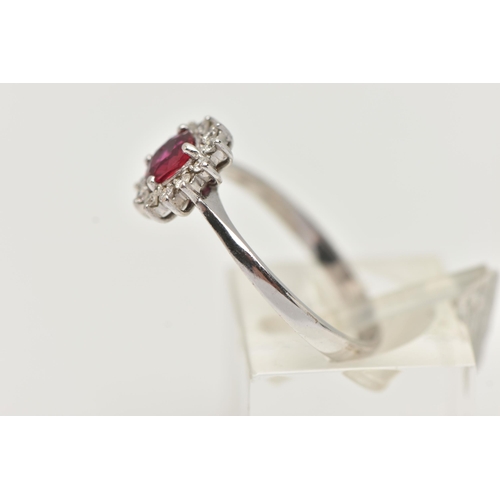 93 - A RUBY AND DIAMOND RING, circular cut ruby prong set in white metal, with a surround of twelve round... 