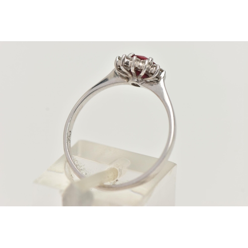 93 - A RUBY AND DIAMOND RING, circular cut ruby prong set in white metal, with a surround of twelve round... 