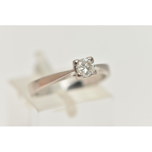 94 - A SINGLE STONE DIAMOND RING, a round brilliant cut diamond four prong set in white gold, leading on ... 