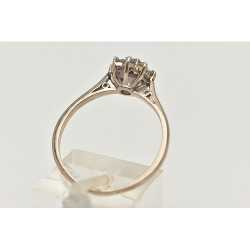 95 - A DIAMOND CLUSTER RING, a round brilliant cut diamond, prong set with a surround of eight single cut... 