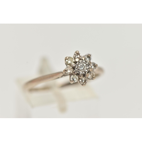 95 - A DIAMOND CLUSTER RING, a round brilliant cut diamond, prong set with a surround of eight single cut... 