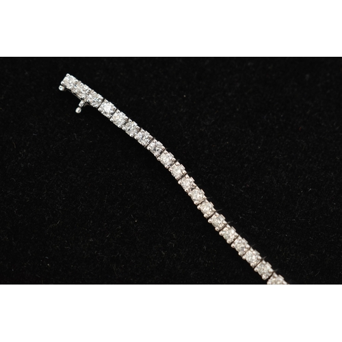 150 - A 9CT WHITE GOLD DIAMOND LINE BRACELET, designed as sixty-four round brilliant cut diamonds each wit... 