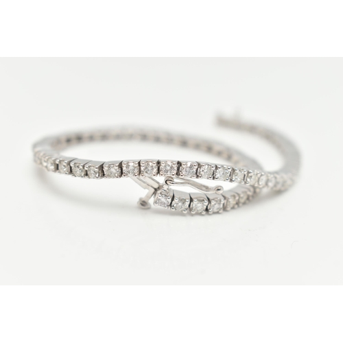 150 - A 9CT WHITE GOLD DIAMOND LINE BRACELET, designed as sixty-four round brilliant cut diamonds each wit... 