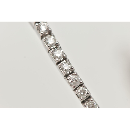 150 - A 9CT WHITE GOLD DIAMOND LINE BRACELET, designed as sixty-four round brilliant cut diamonds each wit... 