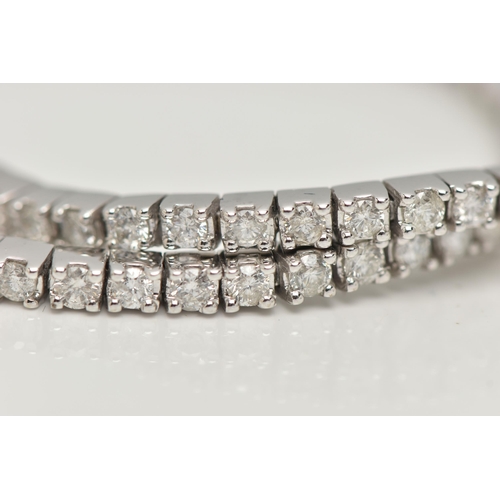 150 - A 9CT WHITE GOLD DIAMOND LINE BRACELET, designed as sixty-four round brilliant cut diamonds each wit... 