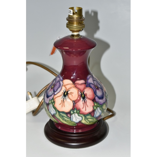 303 - A SMALL MOORCROFT POTTERY 'PANSY' TABLE LAMP, having tube lined pink, purple and orange pansies on a... 