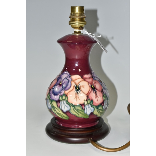 303 - A SMALL MOORCROFT POTTERY 'PANSY' TABLE LAMP, having tube lined pink, purple and orange pansies on a... 