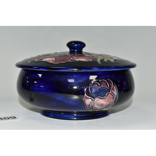 309 - A MOORCROFT POTTERY 'ANENOME' COVERED BOWL, of shallow squat form, having tube lined blue and purple... 