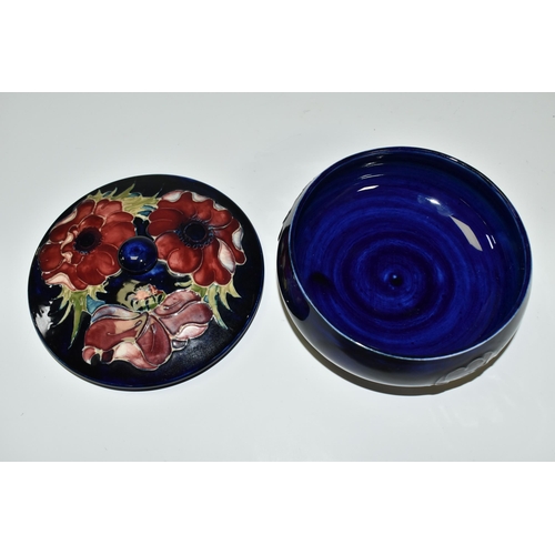 309 - A MOORCROFT POTTERY 'ANENOME' COVERED BOWL, of shallow squat form, having tube lined blue and purple... 