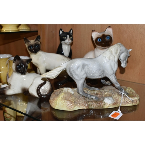 312 - A GROUP OF CERAMIC ANIMAL FIGURES, comprising a Beswick Camargue Wild Horse figure on a ceramic base... 