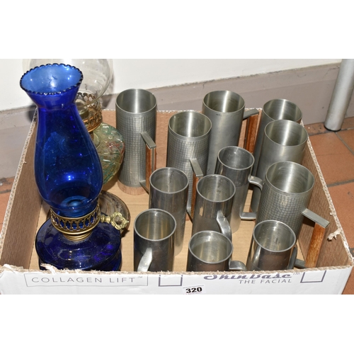 320 - A BOX OF MID TWENTIETH CENTURY PEWTER TANKARDS AND TWO OIL LAMPS, comprising a set of six tankards b... 