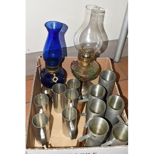 320 - A BOX OF MID TWENTIETH CENTURY PEWTER TANKARDS AND TWO OIL LAMPS, comprising a set of six tankards b... 