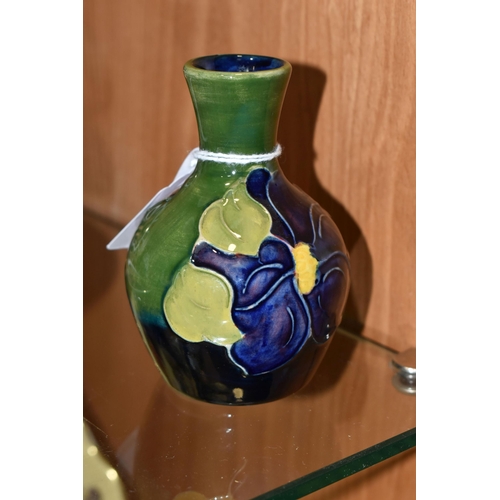 335 - A MOORCROFT POTTERY BUD VASE, in 'Clematis' pattern on a green-blue ground, impressed marks to base,... 