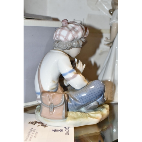 342 - A BOXED LLADRO FIGURINE  'I HOPE SHE DOES', model 5450  depicting young boy pulling petals off flowe... 