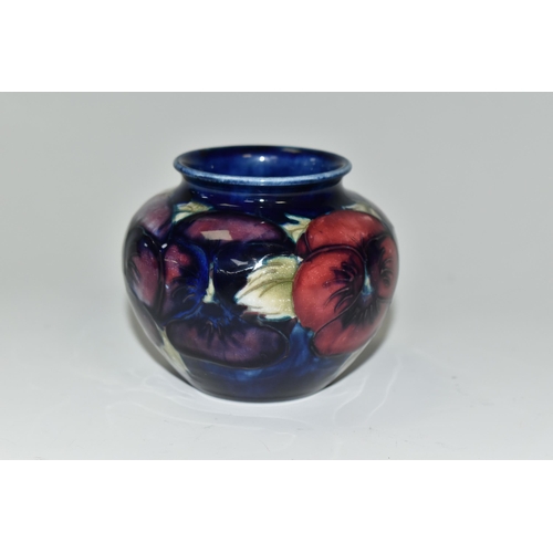 348 - A MOORCROFT POTTERY 'BLUE PANSY' PATTERN SMALL BULBOUS VASE, purple and blue pansies on a dark blue ... 