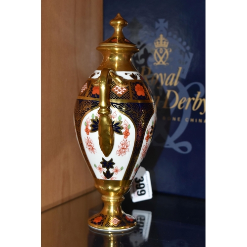 399 - A BOXED ROYAL CROWN DERBY TWIN HANDLED URN, complete with cover, 1128 pattern, approximate height 20... 