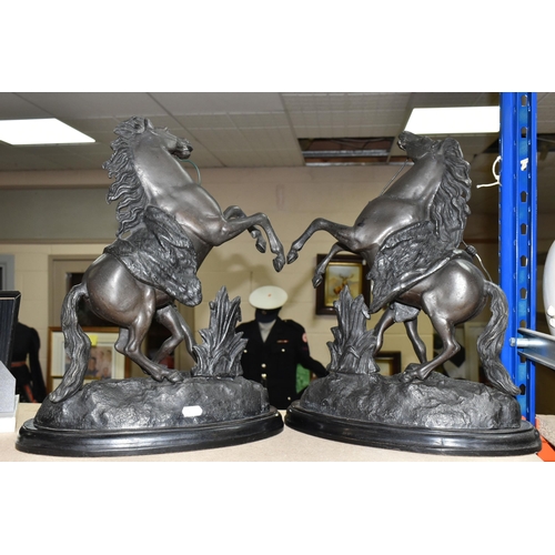 412 - A PAIR OF SPELTER MARLY HORSES, painted black, surmounting a wooden plinth, indistinct signature to ... 