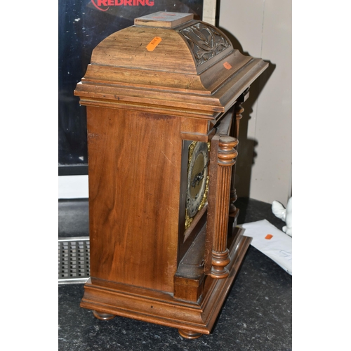 434 - AN EARLY 20TH CENTURY WALNUT CASED CHIMING BRACKET CLOCK, the caddy hood with foliate carved detail,... 