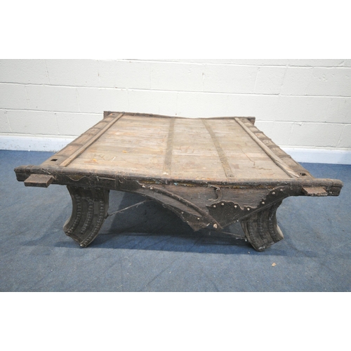 1201 - A MOROCCAN / ANGLO-INDIAN IRON BANDED AND HARDWOOD COFFEE TABLE, on a shaped base, 130cm x depth 132... 