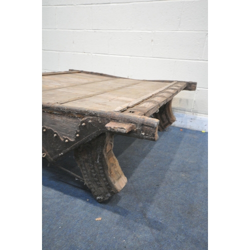 1201 - A MOROCCAN / ANGLO-INDIAN IRON BANDED AND HARDWOOD COFFEE TABLE, on a shaped base, 130cm x depth 132... 