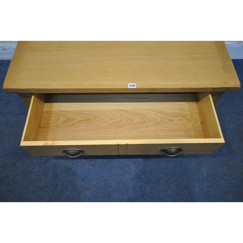 1228 - A MODERN OAK EFFECT COFFEE TABLE, with a double sided single drawer, length 96cm x depth 60cm x heig... 