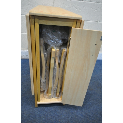 1229 - A MODEN BEECH EFFECT DROP LEAF DINING TABLE, with a single door enclosing four bagged fold away chai... 