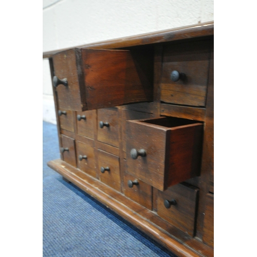 1231 - A REPRODUCTION HARDWOOD TABLE TOP APOTHECARY CHEST, fitted with eighteen drawers, on bracket feet, w... 