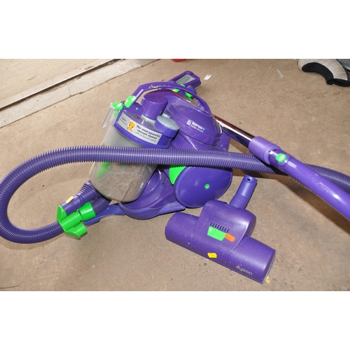 1056 - A DYSON DC05 VACUUM CLEANER with two floor heads and two other accessories (PAT pass and working)