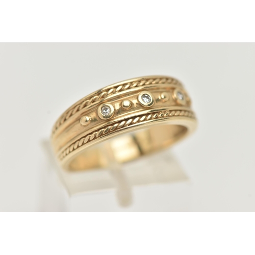 23 - A 9CT GOLD BAND RING, a yellow gold tapered band with rope detail, set with three single cut diamond... 