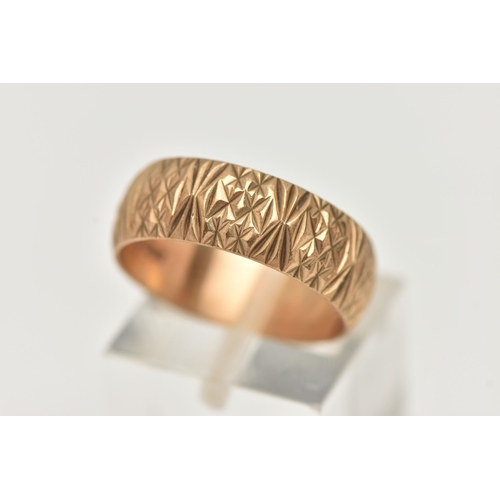 37 - A 9CT YELLOW GOLD RING, designed as a textured band, measuring approximately 7.0mm wide, hallmarked ... 