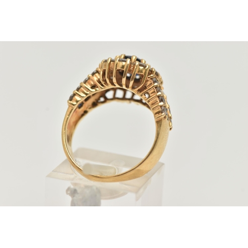 39 - A MODERN 18CT YELLOW GOLD GEM SET AND PASTE CLUSTER RING, set with a principal oval shaped synthetic... 