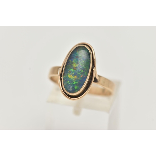 44 - A YELLOW METAL OPAL TRIPLET RING, of an oval design, collet set opal triplet, to a scroll surround a... 