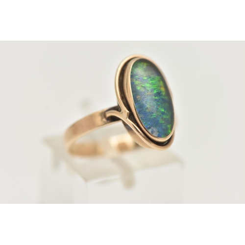 44 - A YELLOW METAL OPAL TRIPLET RING, of an oval design, collet set opal triplet, to a scroll surround a... 