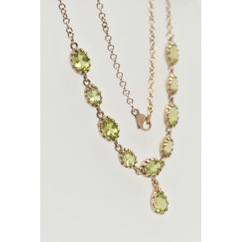 50 - A YELLOW METAL PERIDOT NECKLACE, designed as a row of nine oval cut peridots, each in a claw setting... 