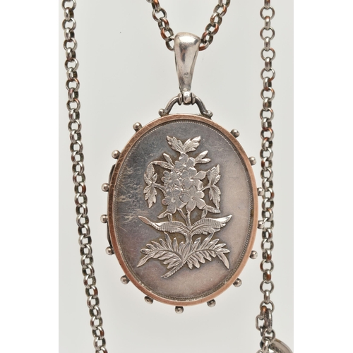 52 - A LATE 19TH CENTURY SILVER LOCKET, a large oval locket with raised floral and foliage detail, a yell... 