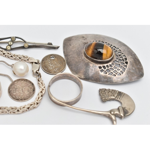 66 - A SMALL ASSORTMENT OF JEWELLERY, to include a white metal abstract brooch set with a tiger eye caboc... 